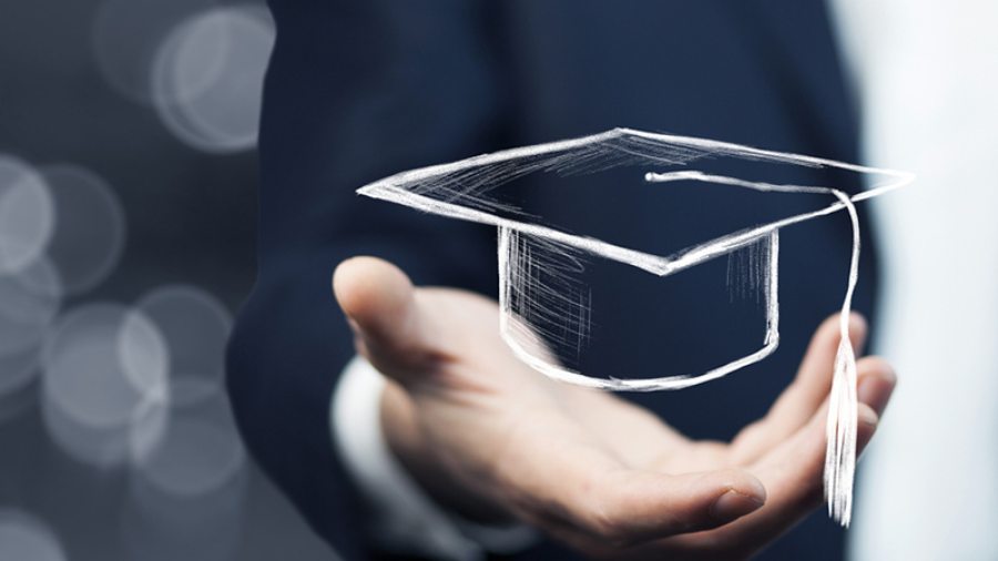 Hand holding a graduation cap